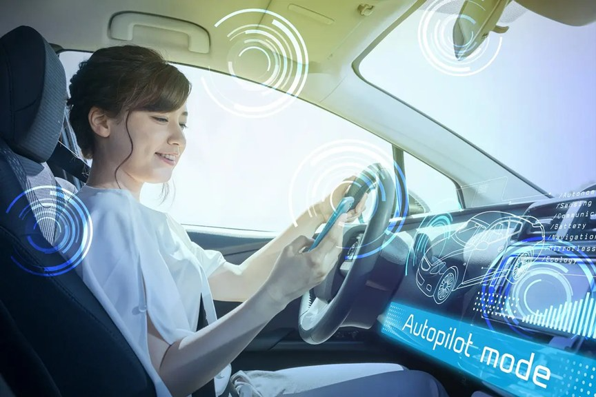 A woman drives a car on autopilot