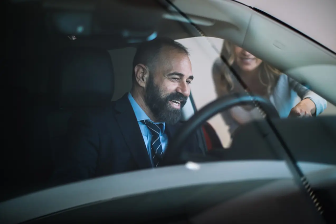 A man sits behind the wheel of a vehicle