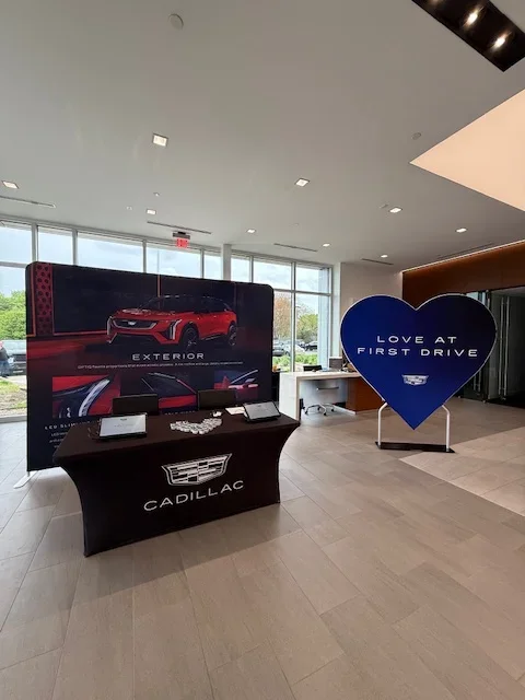 Cadillac showroom display featuring vehicle promotion booth